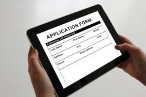 Hands using iPad tablet to fill out online job application