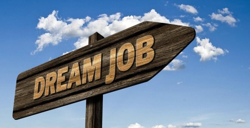 A wooden signpost with the words 'DREAM JOB' in bold letters, pointing toward a bright blue sky with scattered white clouds, symbolizing the pursuit of top in-demand jobs in 2025 such as AI careers, data science roles, cybersecurity jobs, healthcare careers, and renewable energy positions. The image inspires career opportunities in high-paying fields like software development, big data analytics, telemedicine, and sustainable energy, highlighting skills for the future such as machine learning, project management, and ethical hacking.